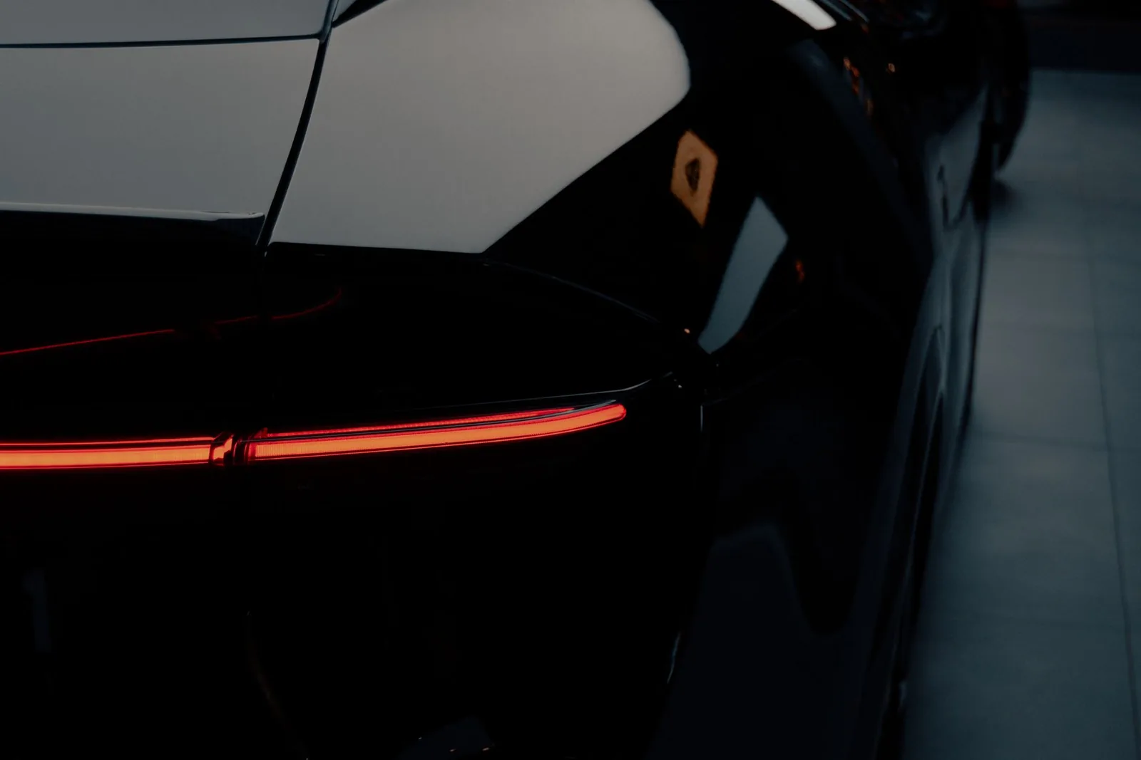 A freshly detailed car with a deep glossy finish under studio light