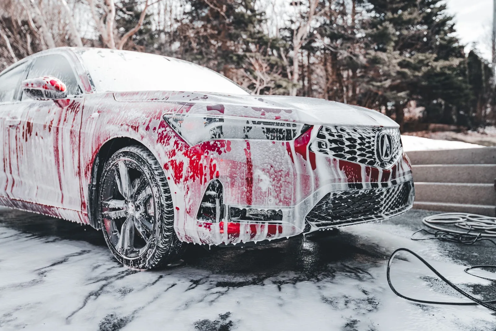 A car covered in foam during an exterior foam wash